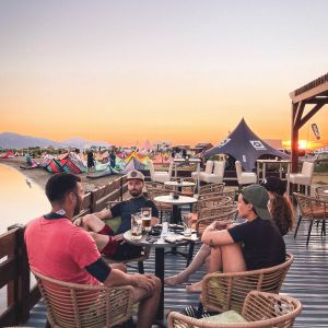 Students enjoying drinks after kitesurfing lessons